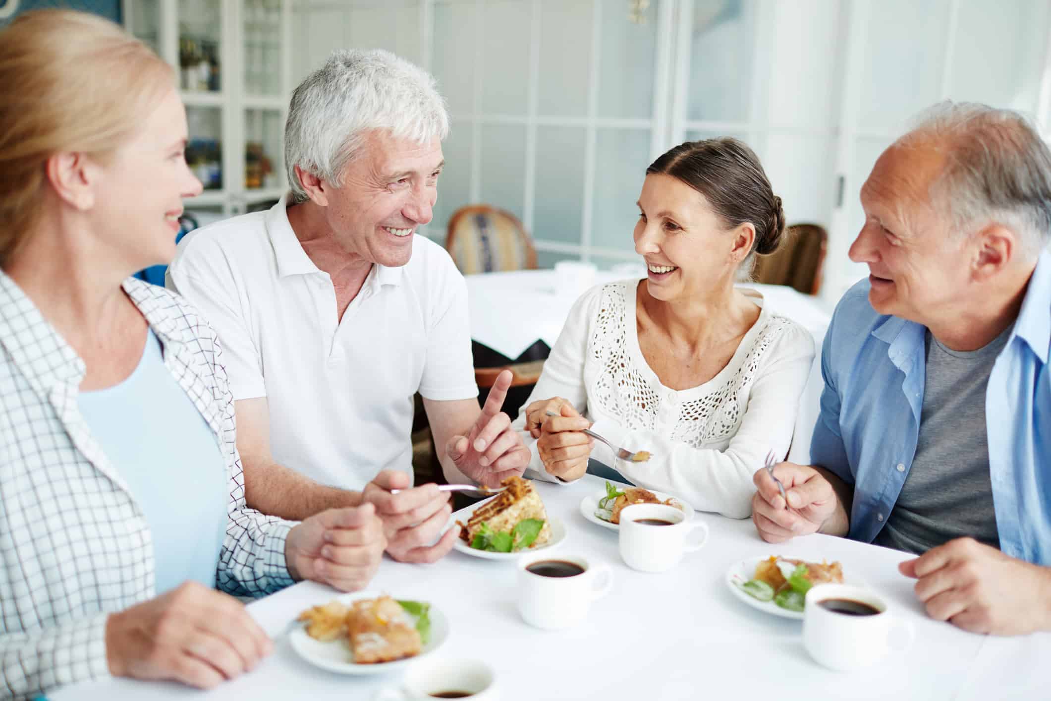 Treating your hearing loss helps you be more able to enjoy conversation over dessert with friends.