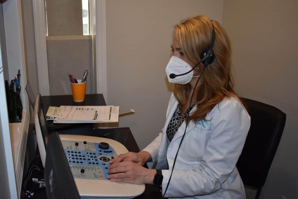 Dr. Ahlberg at hearing aid testing device