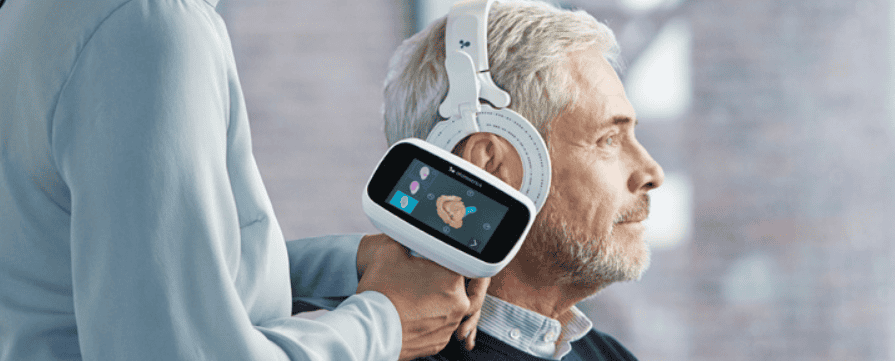 patient with Otoscan 3D scanner and hearing care professional