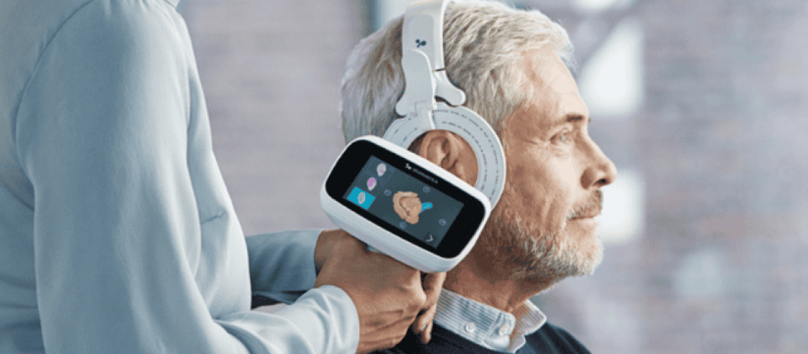 patient with Otoscan 3D scanner and hearing care professional