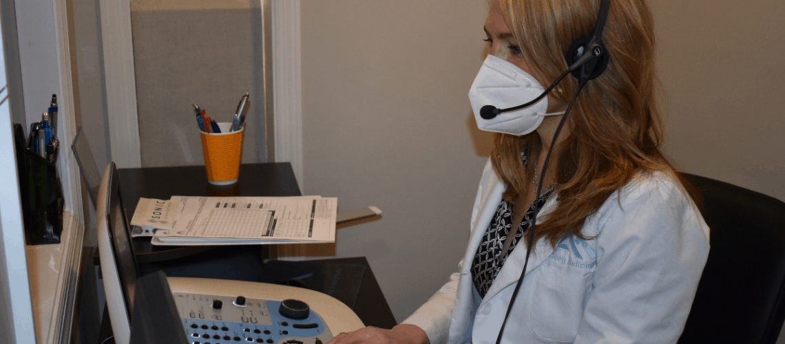 Dr. Ahlberg conducting hearing evaluation test